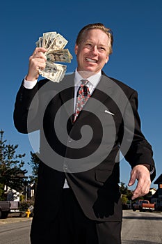 Man fanning himself with money.