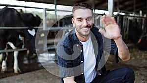 Man or farmer with cows in cowshed on dairy farm