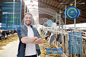 Man or farmer with cows in cowshed on dairy farm