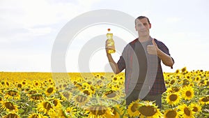 Man farmer hand hold bottle of sunflower oil n the field at sunset lifestyle. Sunflower oil improves skin health and