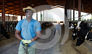 Man farmer posing at cowshed on farm