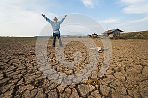 Man farmer pray at climate change global warming danger