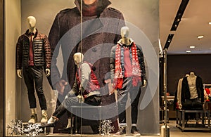 man fashion clothing shop window with mannequins, christmas decoration,dress store window, shop decoration