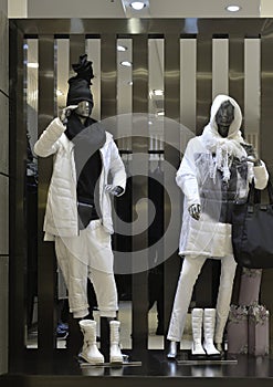 Man Fashion clothing shop window with mannequins in down coat, christmas decoration,dress store window, shop decoration