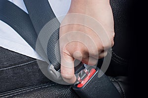 Man fastening seat belt in car. transportation concept