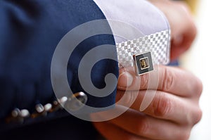 A man fastens a cuff-link