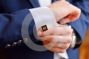 A man fastens a cuff-link