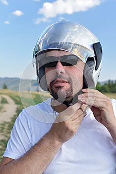 A man fastens his motorcycle