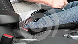 Man fastens his seat belt in the car. Close-up