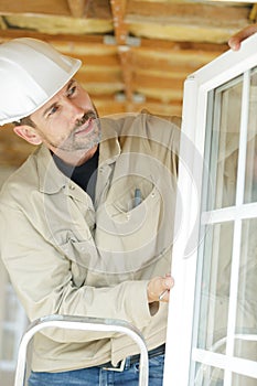 man fastens metal window