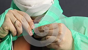 A man fastens a protective coat with buttons. Close-up shot. Virus protection