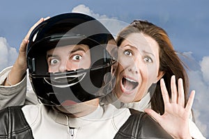 Man and fearful woman on a motorcycle