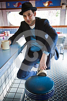 Man in Fedora Sitting at Diner Counter