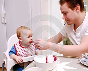 Man feeding baby