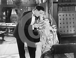 Man feeding food on a fork to a woman