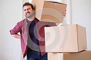 Man feeling back ache cramp moving heavy boxes