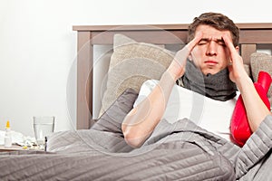 Man feeling bad lying in the bed and coughing