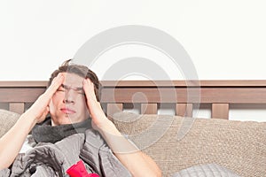 Man feeling bad lying in the bed and coughing