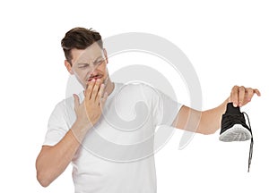 Man feeling bad smell from shoe