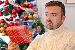 Man feeling disappointed for a bad Christmas present