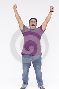 A man, feeling exhilarated, throwing his hands in the air. Celebrating victory, overwhelmed with joy. Full body photo, isolated on