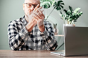 A man feeling pain in his hand, rheumatoid arthritis and joints inflammation concept