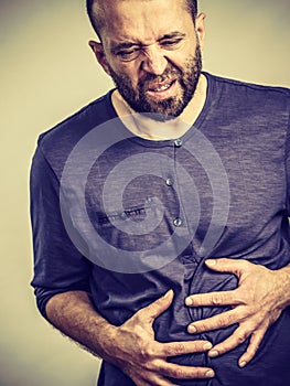 Man feeling stomach ache pain