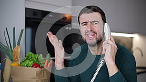 Man feeling stressed out after a telemarketing call