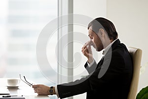 Man feels fatigue in eyes after work in office