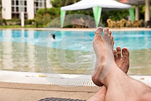 Man feet at swimming pool