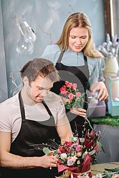 Man and female making choice of fresher flowers