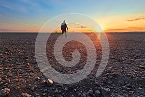 Man in field at sunset