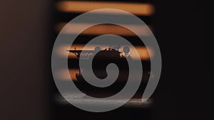 Man figure walking on platform supply vessel helipad in setting sun light