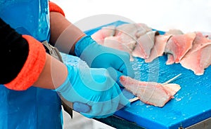 Man filleting fish in close up photo