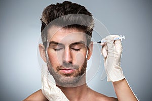 Man filling facial wrinkles