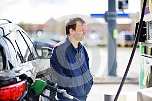 Man filling gasoline fuel