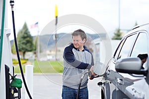 Man filling gasoline fuel in car