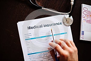 man filling medical insurance policy