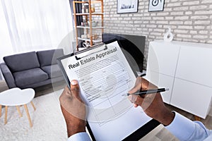 Man Filling Real Estate Appraisal Form