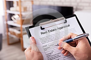Man Filling Real Estate Appraisal Form