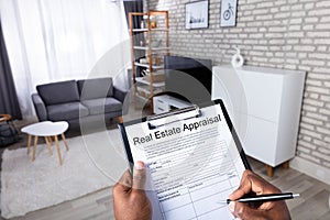 Man Filling Real Estate Appraisal Form photo