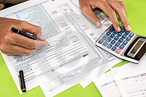 Man filling tax form with pen