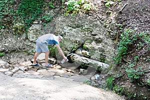 Man fills botle from Silver Spring in Shapsuga