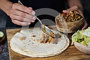 Man fills a durum or a burrito