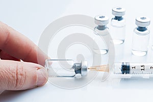 Man fills an insulin syringe with medicine from a vial