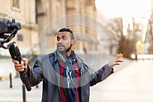 Man filming a vlog with camera in the city