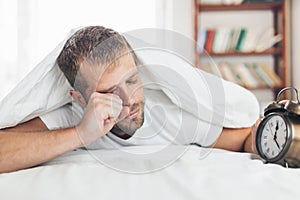 Man finding it difficult to wake up in the morning