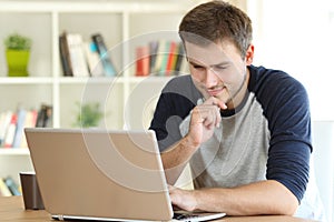 Man finding interesting content on line in a laptop