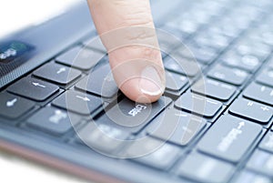 Man finger on the enter key.