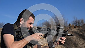 Man firing customised russian machine gun, medium